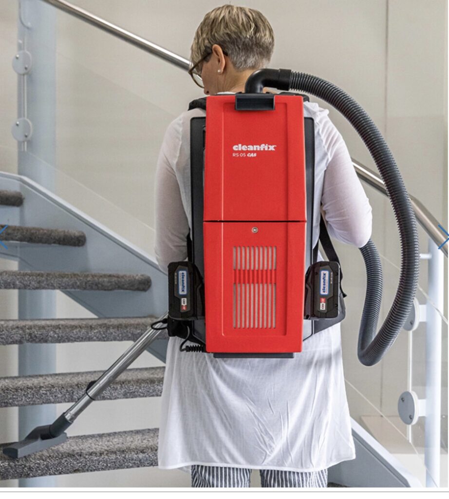 Person using a backpack vacuum